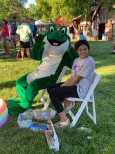 June Jam photo the Bags of Fun frog mascot and a young woman