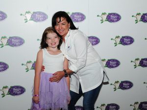 Photo of tammy with a child at an event