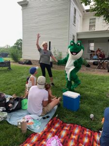 Woman dancing with Chuckles the Frog